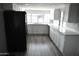 Modern kitchen featuring white cabinets, gray flooring and stainless steel appliances at 17836 N 21St St, Phoenix, AZ 85022