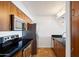 Modern kitchen with wood cabinets, granite countertops, and stainless steel appliances at 3313 N 68Th St # 203, Scottsdale, AZ 85251