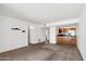 Open living room with kitchen, carpeted floors, and neutral color palette at 3313 N 68Th St # 203, Scottsdale, AZ 85251