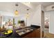 Kitchen features double sink, wood cabinets, and a view into the living room at 3313 N 68Th St # 203, Scottsdale, AZ 85251