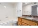 Clean bathroom with granite countertop, wood cabinet, and bathtub at 930 Leisure World --, Mesa, AZ 85206