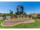 Community entrance with a globe fountain and landscaping at 930 Leisure World --, Mesa, AZ 85206