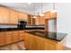Kitchen with light wood cabinets, granite countertops, and island at 930 Leisure World --, Mesa, AZ 85206