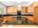 Kitchen boasts granite countertops and wood cabinets at 930 Leisure World --, Mesa, AZ 85206