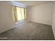 Well-lit bedroom featuring neutral wall tones and carpet at 7857 E Flossmoor Ave, Mesa, AZ 85208