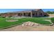 Landscaped backyard with a putting green and stone pathway at 7855 E Kramer St, Mesa, AZ 85207