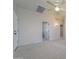 Bright bedroom with neutral walls, carpet, and door to hallway at 7855 E Kramer St, Mesa, AZ 85207