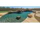 Relaxing pool with waterfall, surrounded by rocks and a grassy area at 7855 E Kramer St, Mesa, AZ 85207