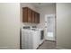 Laundry room with washer, dryer, and built-in cabinets at 7855 E Kramer St, Mesa, AZ 85207