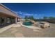 Large pool with a waterfall and spa, surrounded by a gravel patio at 7855 E Kramer St, Mesa, AZ 85207