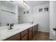 Double vanity bathroom with dark wood cabinets and tile flooring at 7855 E Kramer St, Mesa, AZ 85207