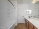Bathroom with a shower/tub combo, double vanity, and tile floors at 7855 E Kramer St, Mesa, AZ 85207
