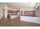 Open kitchen with an island, wood cabinets, and a view into the adjacent living area at 7855 E Kramer St, Mesa, AZ 85207