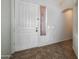 Bright entryway with tile flooring and a white front door at 7855 E Kramer St, Mesa, AZ 85207