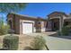 Single story home with a two car garage and nicely landscaped front yard at 7855 E Kramer St, Mesa, AZ 85207
