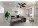 Bright home office features a large desk, comfortable chair, and ample natural light at 7855 E Kramer St, Mesa, AZ 85207