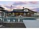 Community swimming pool with lounge chairs and umbrellas at 3581 E Alexander Dr, San Tan Valley, AZ 85143