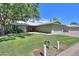 Ranch style home with carport and well-manicured lawn at 4906 E Lake Point Cir, Phoenix, AZ 85044