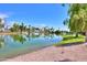 Scenic view of a lake with palm trees and lush greenery at 4906 E Lake Point Cir, Phoenix, AZ 85044