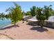 Backyard view of home with screened patio and lake access at 4906 E Lake Point Cir, Phoenix, AZ 85044