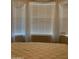 Bright bedroom with bay window, featuring window blinds and sheer curtains at 2233 E Behrend Dr # 41, Phoenix, AZ 85024