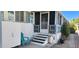Mobile home exterior with a screened porch and steps at 2233 E Behrend Dr # 41, Phoenix, AZ 85024
