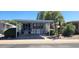 Mobile home exterior with carport, landscaping, and palm trees at 2233 E Behrend Dr # 41, Phoenix, AZ 85024
