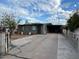 Gray house with driveway, landscaping, and gate at 2209 E Sheridan St, Phoenix, AZ 85006