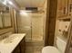 Clean bathroom with tub and shower, vanity, and wood cabinets at 2323 W Pomo Ave, Apache Junction, AZ 85119