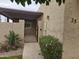 Condo entrance with gate, landscaping, and exterior lighting at 3345 E University Dr # 25, Mesa, AZ 85213