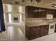 Kitchen with breakfast bar and view into the living room at 3345 E University Dr # 25, Mesa, AZ 85213