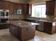 Well-equipped kitchen with granite countertops and dark wood cabinets at 21956 N 59Th Ln, Glendale, AZ 85310