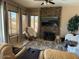 Cozy Gathering room features stone fireplace, large TV, and ample seating at 21956 N 59Th Ln, Glendale, AZ 85310