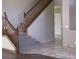 Elegant wooden staircase with carpet runner and tile flooring at 21956 N 59Th Ln, Glendale, AZ 85310