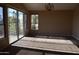 Spacious bedroom with large windows, carpet, and a balcony view at 21956 N 59Th Ln, Glendale, AZ 85310