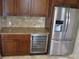 Kitchen features wine cooler, refrigerator, and granite counters at 21956 N 59Th Ln, Glendale, AZ 85310