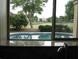 Kitchen window view of a refreshing pool and lush green landscape at 21956 N 59Th Ln, Glendale, AZ 85310