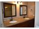 Double vanity bathroom with granite countertops and mirrors at 21956 N 59Th Ln, Glendale, AZ 85310