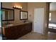Double vanity bathroom with granite countertops and dark wood cabinets at 21956 N 59Th Ln, Glendale, AZ 85310