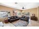 Spacious living room with leather sofas and a view of the backyard at 19667 N Marquez Cir, Maricopa, AZ 85138