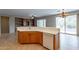 Kitchen island with double sink, dishwasher, and breakfast bar at 13441 W El Sueno Ct, Sun City West, AZ 85375