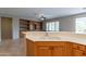 Kitchen with double sink, oak cabinets, and views into the living area at 13441 W El Sueno Ct, Sun City West, AZ 85375