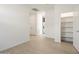 Bright hallway with neutral walls and wood-look flooring, leading to pantry at 3073 E Hayden Rose Ave, San Tan Valley, AZ 85143