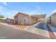 Tan and maroon manufactured home with carport and desert landscaping at 6835 W Taylor St # 208, Phoenix, AZ 85043