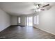 Open and bright living room with wood-look tile flooring and sliding glass doors to the backyard at 7021 S 42Nd St, Phoenix, AZ 85042