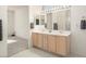 Spacious bathroom with double vanity, large mirror, and ample storage at 16121 W Silver Falls Dr, Surprise, AZ 85374