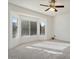 Well-lit bedroom with a large window and carpet flooring at 16121 W Silver Falls Dr, Surprise, AZ 85374