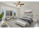 Spacious bedroom with large windows and virtually staged furniture at 16121 W Silver Falls Dr, Surprise, AZ 85374