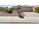 Attractive single-story home with desert landscaping and a two-car garage at 16121 W Silver Falls Dr, Surprise, AZ 85374