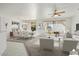 Bright living room features a dining area and virtually staged furniture at 16121 W Silver Falls Dr, Surprise, AZ 85374